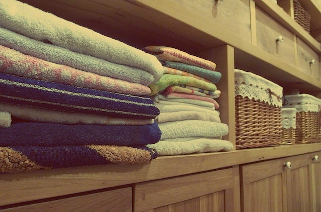 Folded towels on a wooden shelf