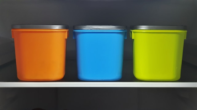 Orange, blue, and green plastic containers or rat bait box