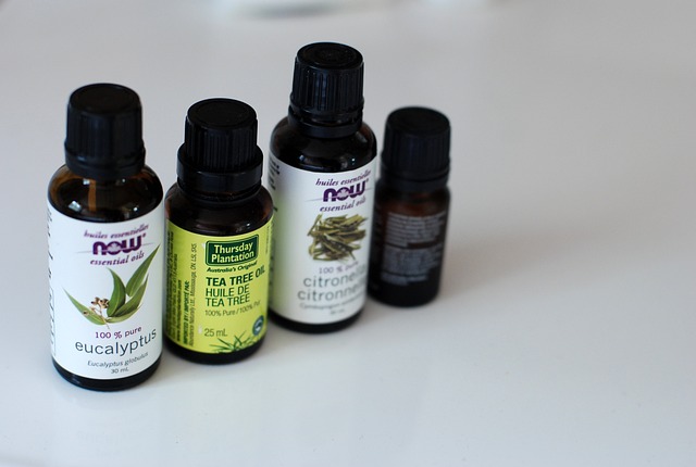 Multiple essential oil bottles in a row, including tea tree oil