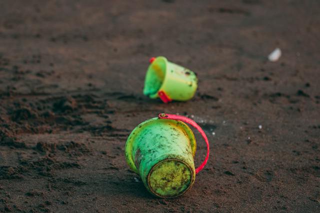 two green buckets on soil